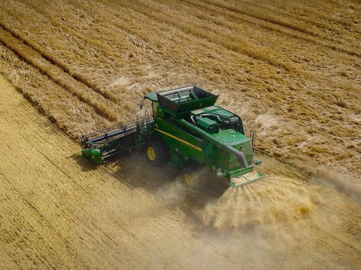 Aerial view of a combine harvester working a field